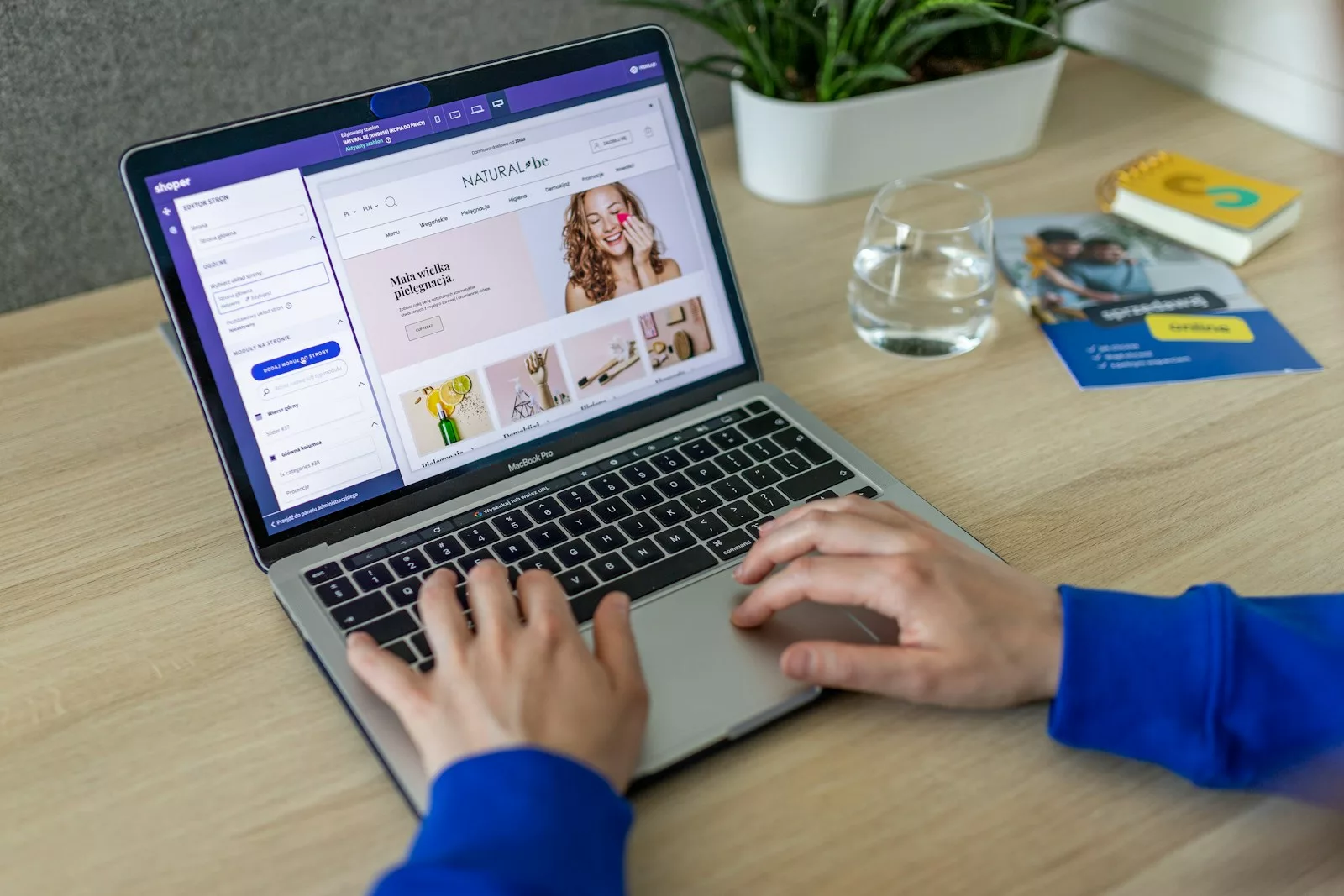 a person typing on a laptop on a table using an ecommerce site